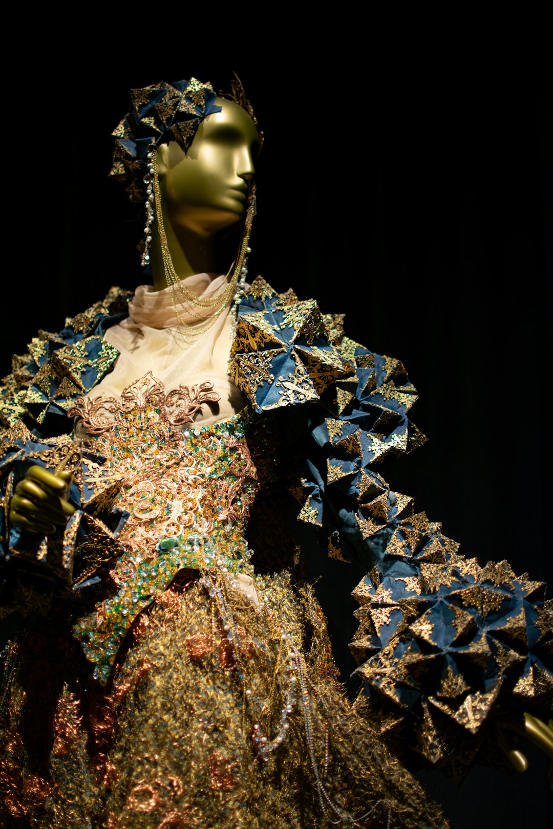 elaborate-golden-gown-with-intricate-blue-triangular-embellishments-xsqsk1jnpig